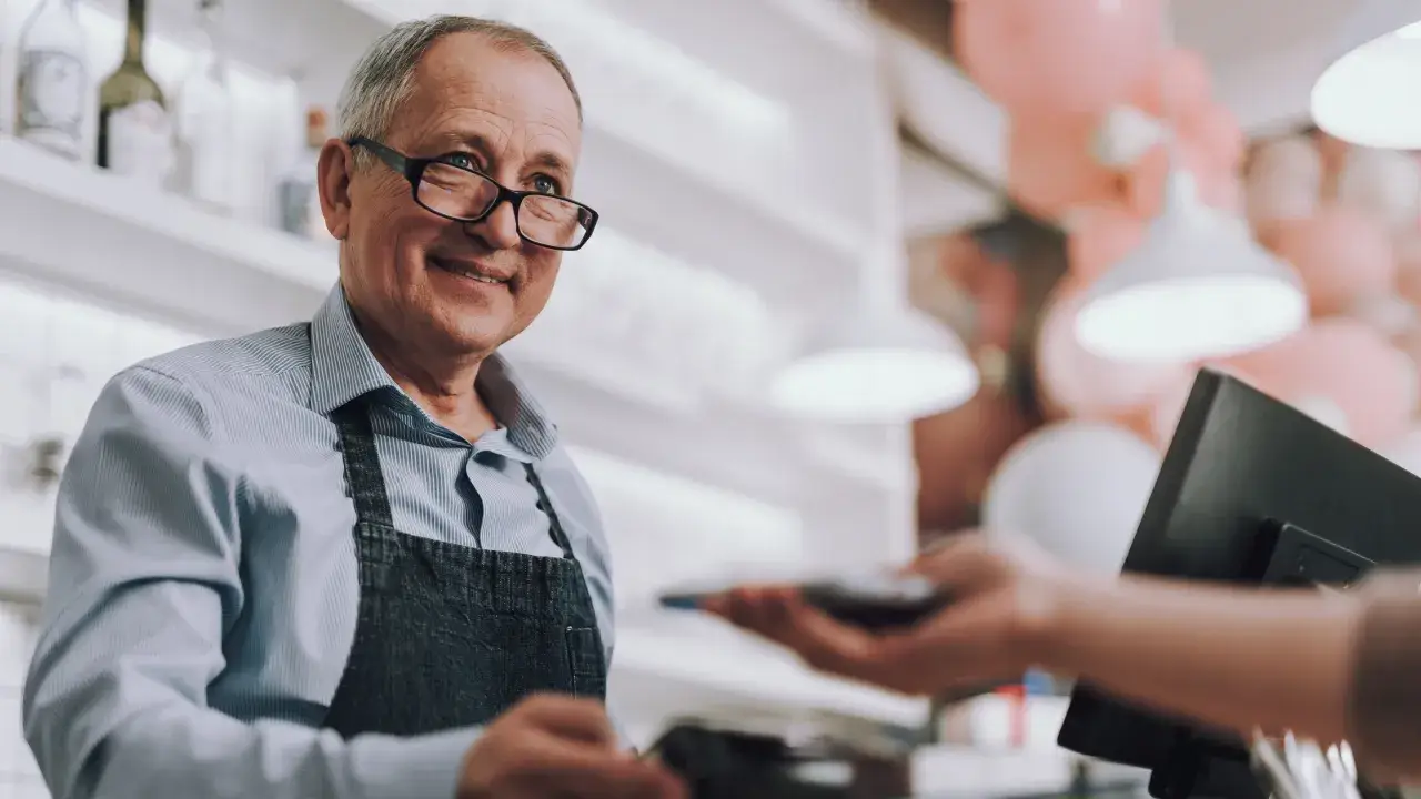 Cashier interacting with a customer at the POS with cloudbased TSS