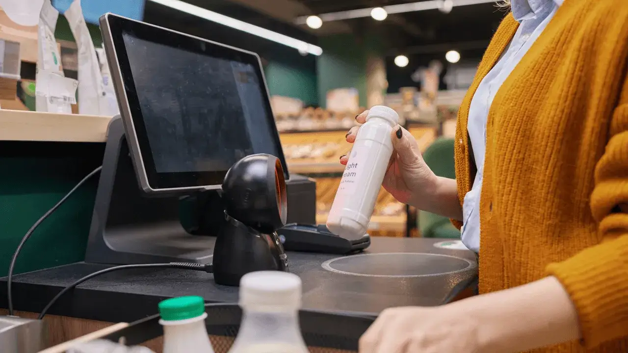 close-up of a person scanning products at the checkout